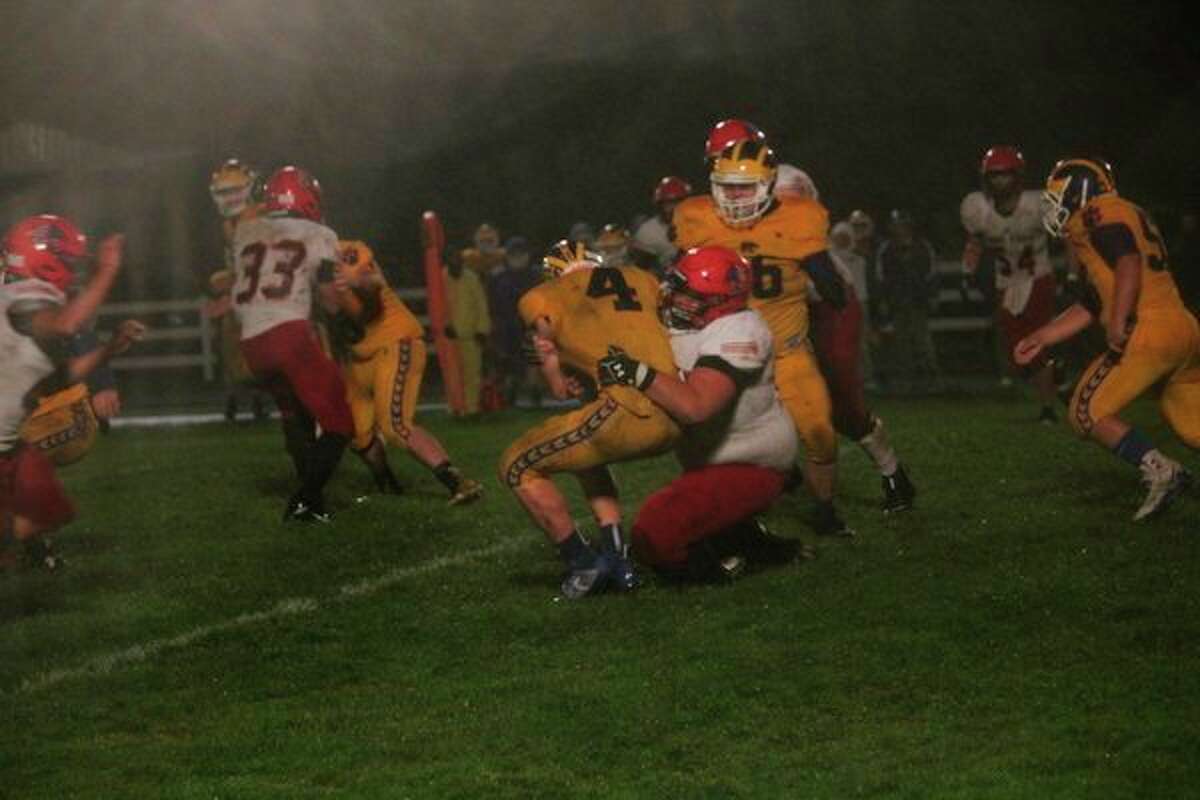 Evart's Justin O'Dell (4) is stopped by the Lake City defense in Friday's game. (Herald Review photo/John Raffel)