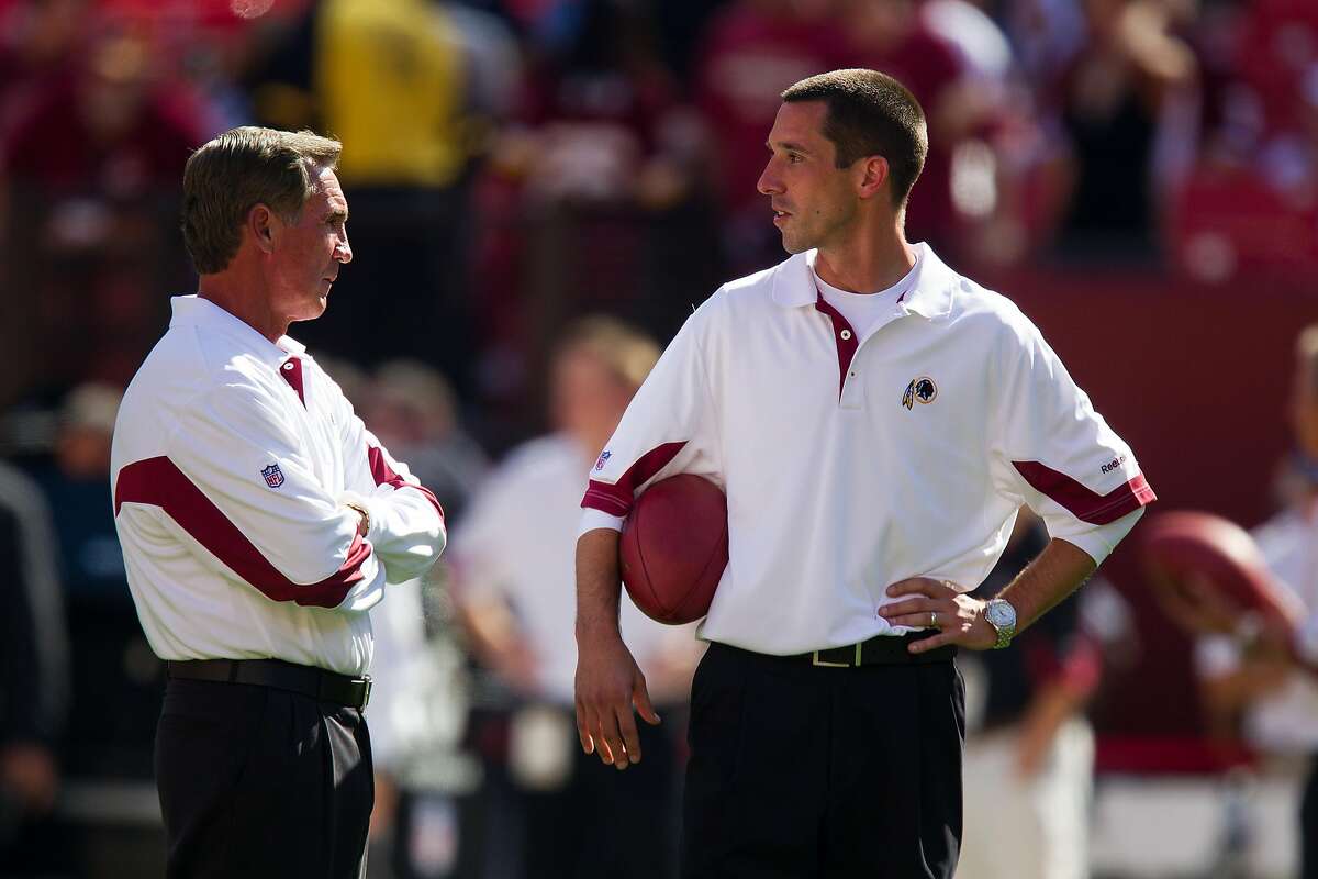 Washington Redskins head coach Mike Shanahan, left, talks with his son, current Redskins and former Houston Texans offensive coordinator Kyle Shanahan before an NFL football game against the Houston Texans at FexEx Field on Sunday, Sept. 19, 2010, in Landover, Md. ( Smiley N. Pool / Houston Chronicle )