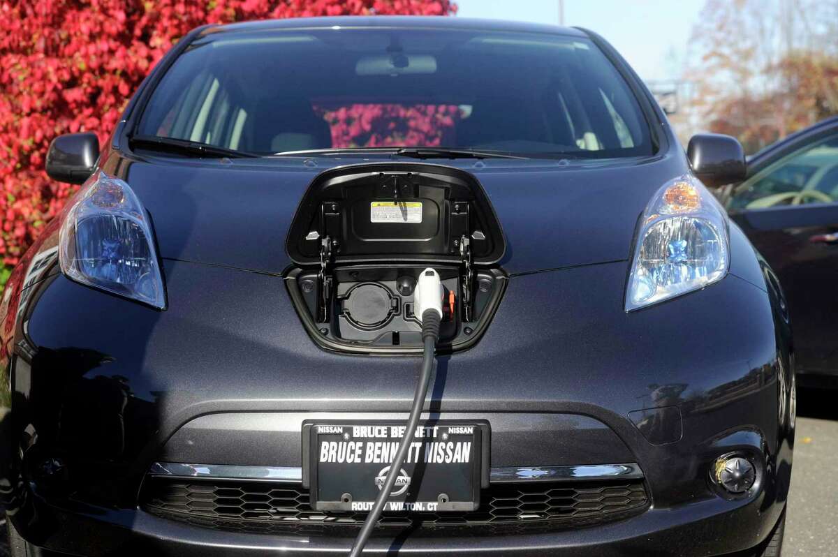 A town-owned electric car is charged at a charging station at the Ridgefield Playhouse in Ridgefield, Conn.