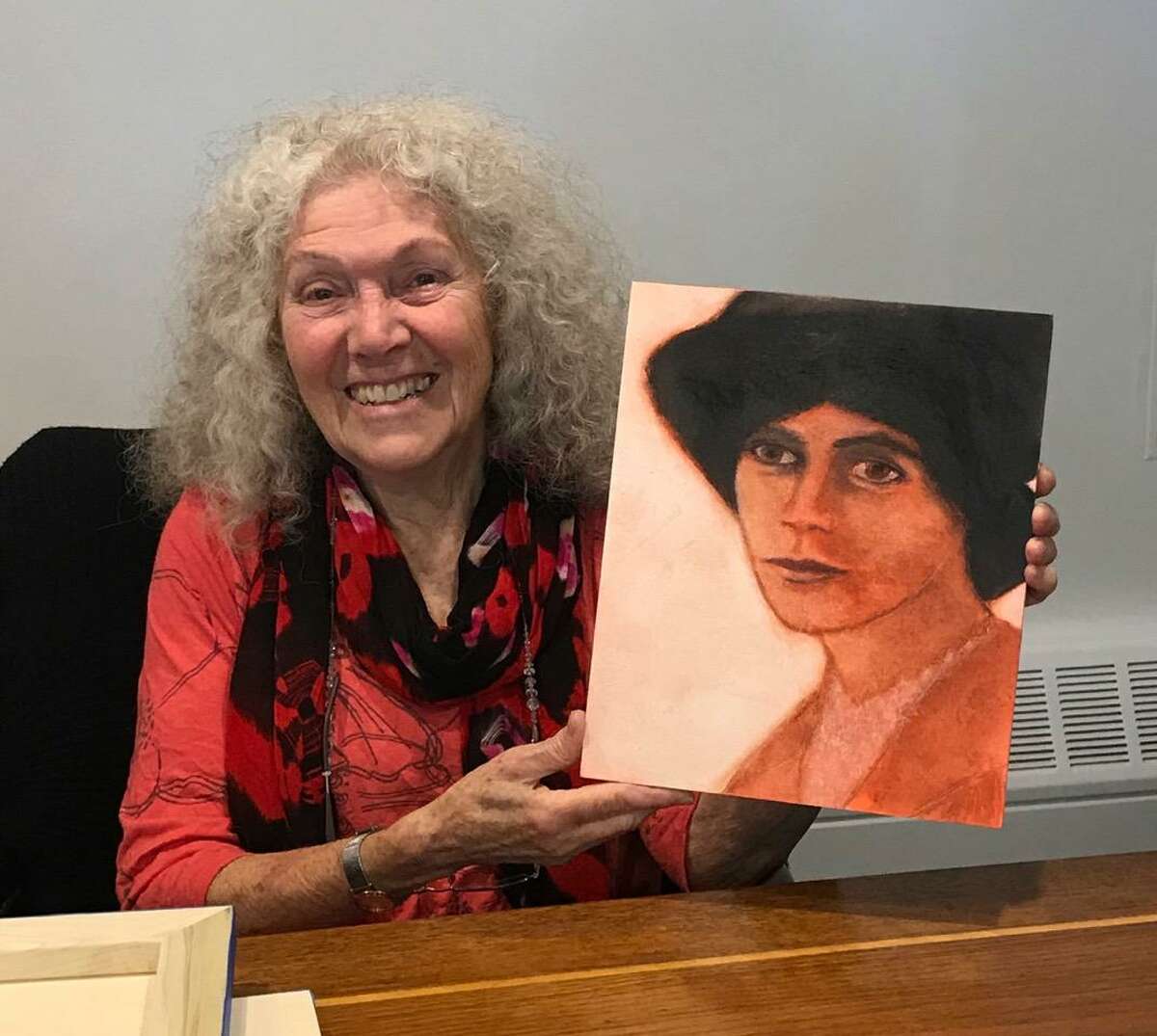 Artist Suzanne Benton with her portrait of Alice Paul.