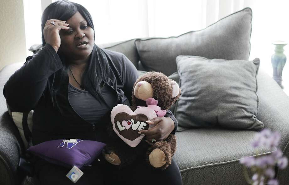 Jessica Byas-Lurgio holds a teddy bear that belonged to her half-sister. Byas-Lurgio had custody of the little girl when she was severely burned. A doctor accused Byas-Lurgio of intentionally burning the child. Photo: Elizabeth Conley/Staff Photographer