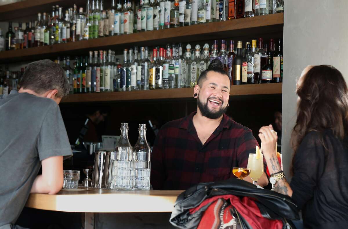 Bartender Christian Suzuki (middle) talks with Celisse Berumen (right) at Elda on Tuesday, Oct. 8, 2019, in San Francisco, Calif.