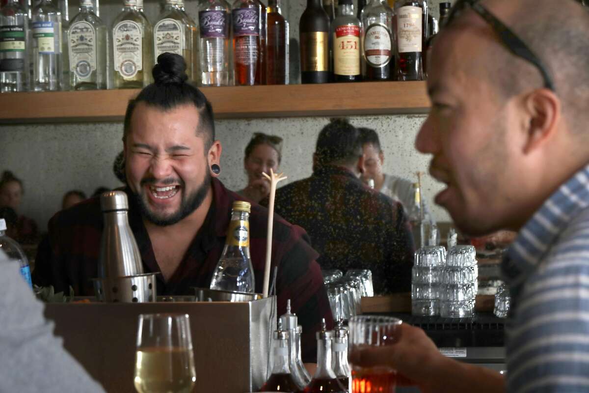 Bartender Christian Suzuki talks with customers including Randy Lee (right) from San Francisco at Elda while serving drinks on Tuesday, Oct. 8, 2019, in San Francisco, Calif.