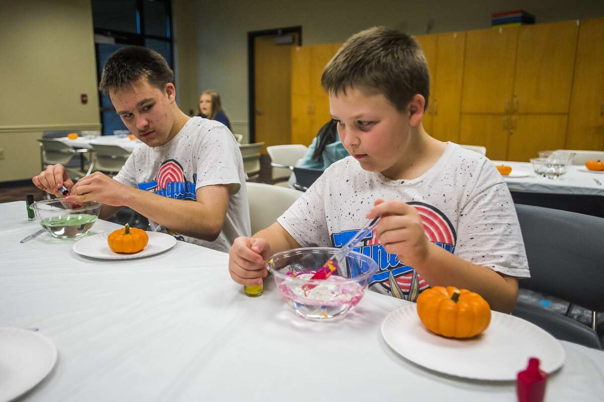 Children choose different colors of nail polish to adorn pumpkins with during a craft Tuesday, Oct. 15, 2019 at the Auburn Area Branch Library. (Katy Kildee/kkildee@mdn.net)
