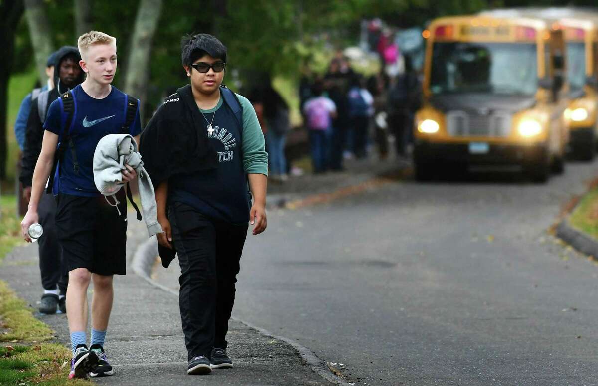 Norwalk High School students exit the school following dismissal Wednesday. The Board of Education voted Tuesday in favor of changing the start times at Norwalk and Brien McMahon high schools. Norwalk high school students will be in class from 8:30 a.m. to 3:15 p.m. starting next fall.