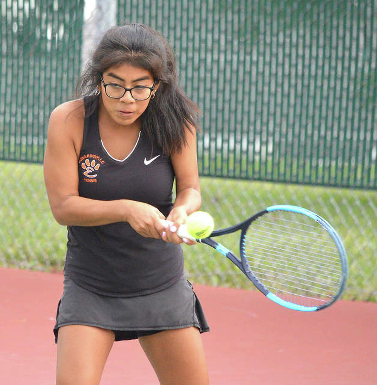 Edwardsville junior Chloe Trimpe makes a backhand return during her No. 1 doubles match on Tuesday in the Southwestern Conference Tournament at the EHS Tennis Center.
