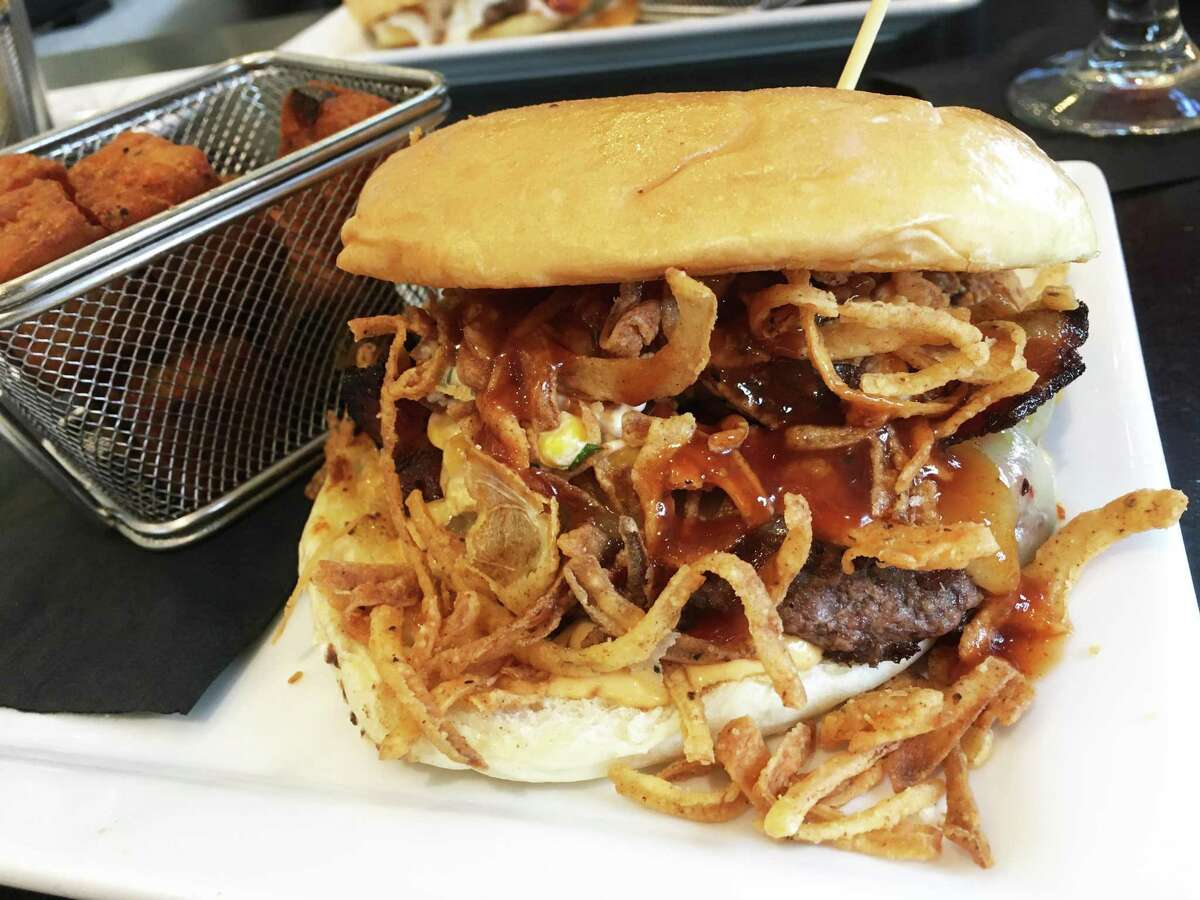 The Street Cred burger at Muck & Fuss includes Mexican street corn, jalapeño bacon, pepper jack cheese and fried onion strings.
