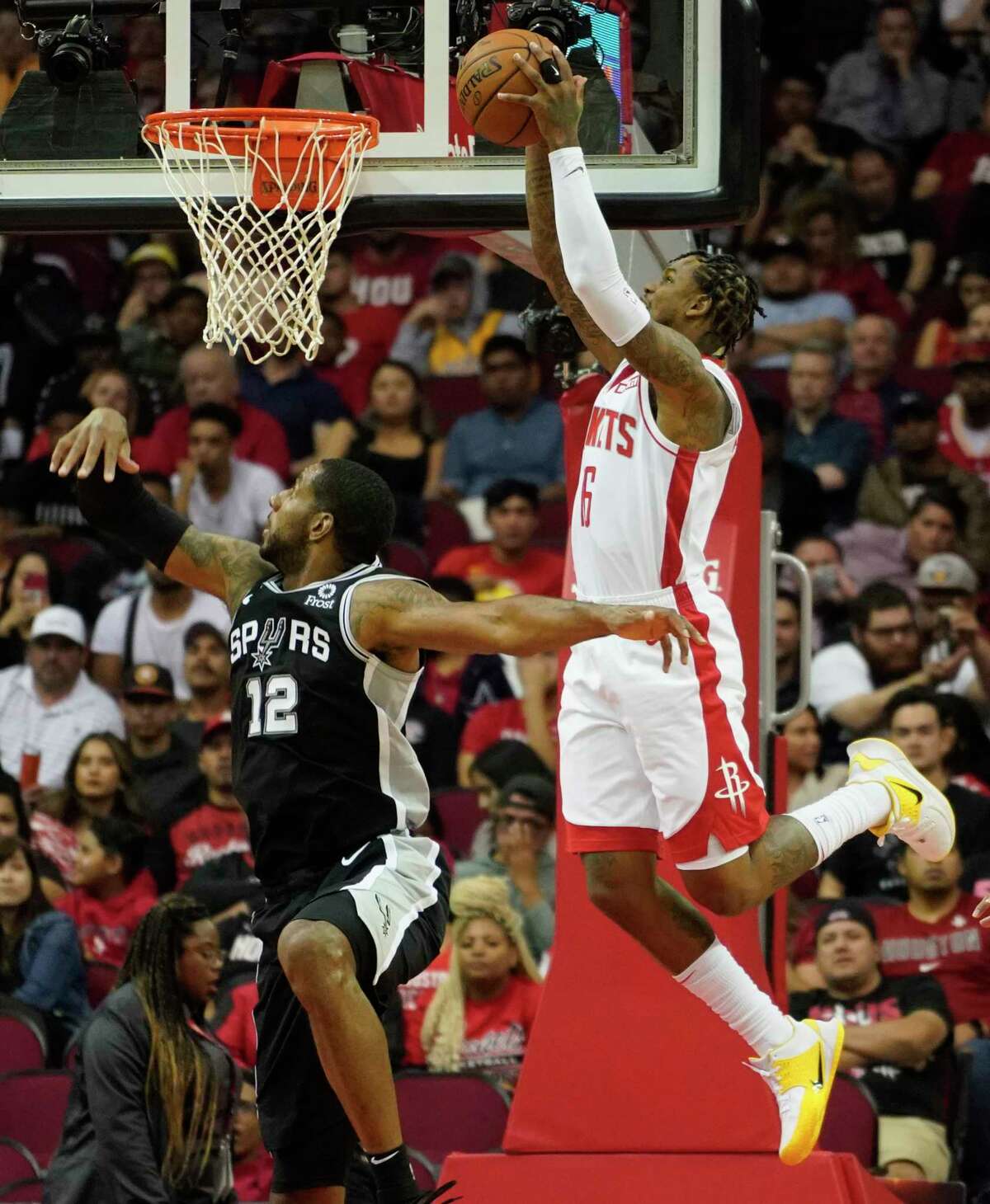 Houston Rockets Ben McLemore dunks the ball past San Antonio Spurs LaMarcus Aldridge during the first half of NBA game at Toyota Center Wednesday, Oct. 16, 2019, in Houston.