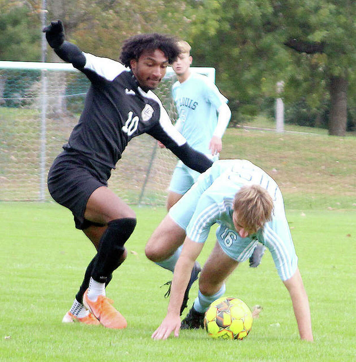 LCCC’s Reshaun Walkes, left, battles with James Grainger of STLCC Wednesday. Walkes scored the first goal in his team’s 3-1 victory.
