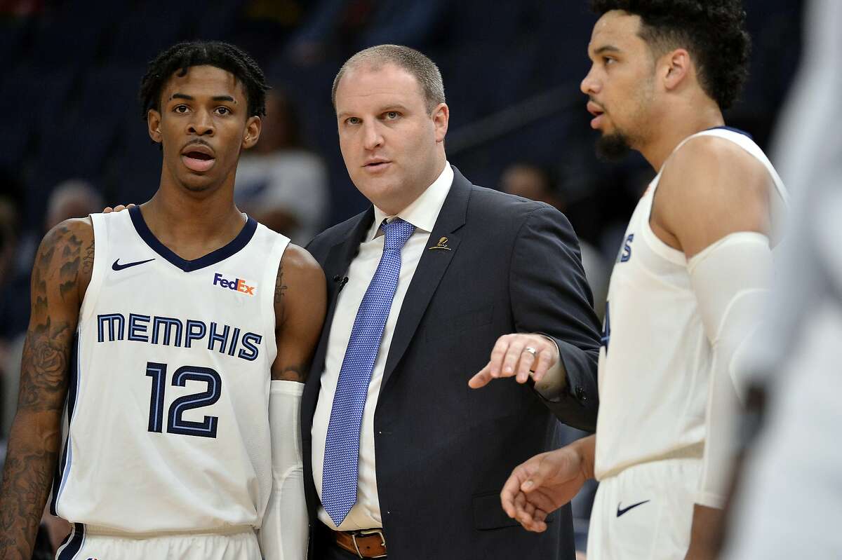 Memphis Grizzlies head coach Taylor Jenkins, center, talks with guards Ja Morant (12) and Dillon Brooks in the first half of an exhibition NBA basketball game against Maccabi Haifa Sunday, Oct. 6, 2019, in Memphis, Tenn. (AP Photo/Brandon Dill)