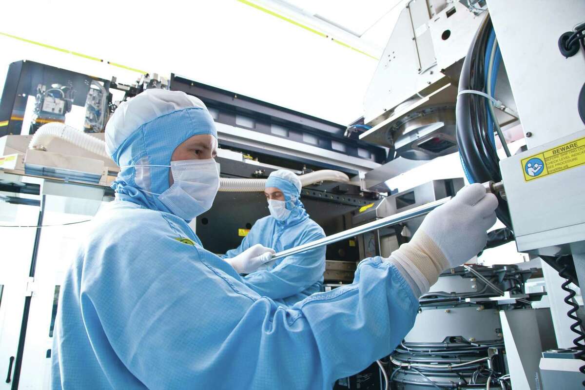 An ASML technician works on a Twinscan lithography system. (Fille photo courtesy ASML)