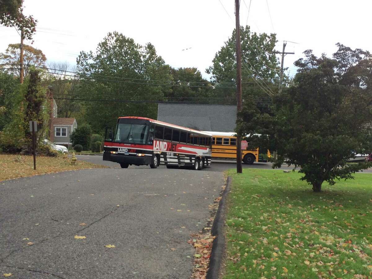 A coach bus on its way to pick up students at St. Theresa School for a field trip got stuck Thursday morning when it could not make the turn onto Rosemond Terrace. The trip had already been canceled due to the delayed opening, but the driver said he had left Waterbury at 7 a.m. and had not been informed the trip was off.