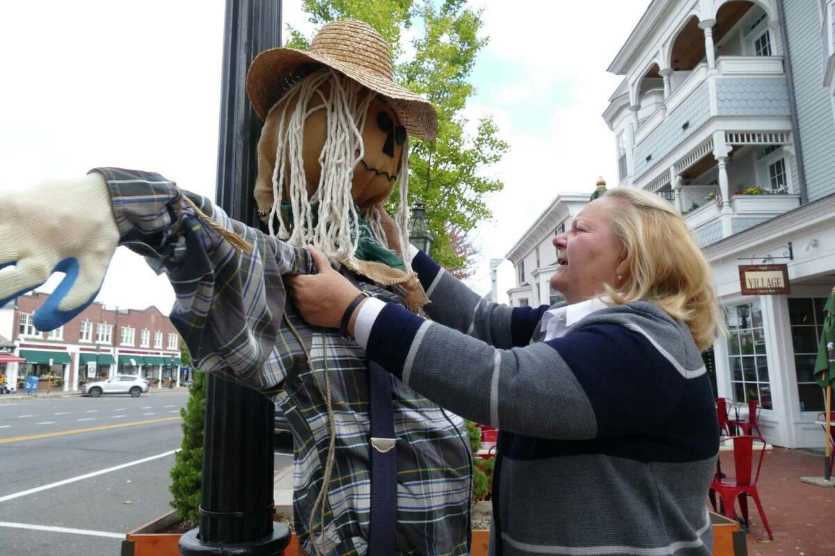 Hilary Micalizzi, executive director of Keeler Tavern Museum, puts Timothy the scarecrow out on Main Street in advance of this week’s Fall in Love with Ridgefield celebration.
