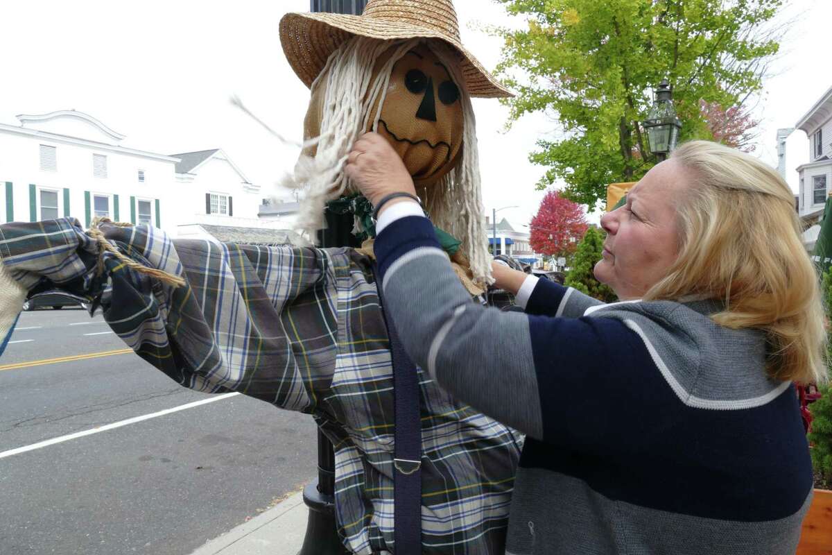 Hilary Micalizzi, executive director of Keeler Tavern Museum, puts Timothy the scarecrow out on Main Street in advance of this week’s Fall in Love with Ridgefield celebration.