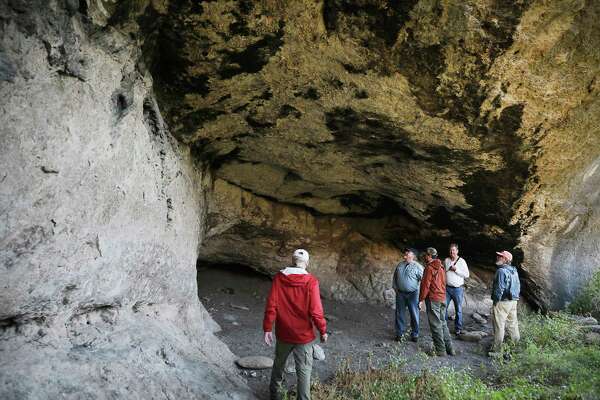 A group hiked up a mountain side to visit a cave named la Cueva de Elvira in Reserva Del Carmen.