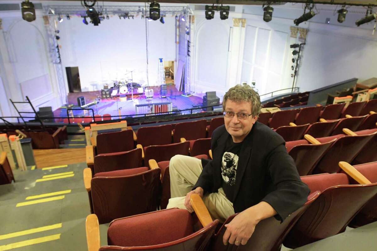 Jonathan Newell, founder and executive and artistic director of the Hudson River Music Hall Productions Inc., sits in the balcony inside the Hudson River Music Hall Strand Theatre on Thursday, Oct. 17, 2019, in Hudson Falls, N.Y. The building was last used as the Kingsbury Town Hall before the Hudson River Music Hall Productions Inc. purchased the building. (Paul Buckowski/Times Union)