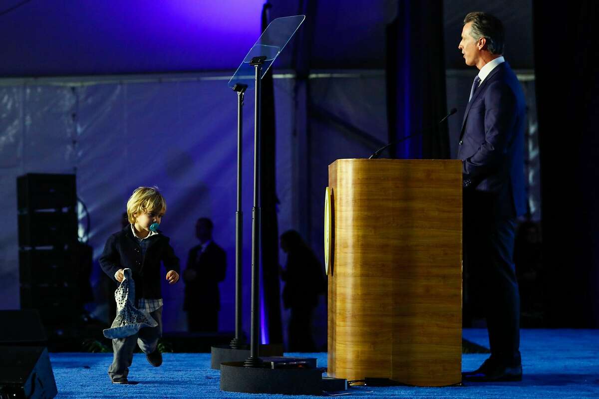 Dutch Newsom, 2, runs up on stage for a second time as his father Governor Gavin Newsom gives his inauguration speech in Sacramento, California, on Monday, January 7th, 2019.