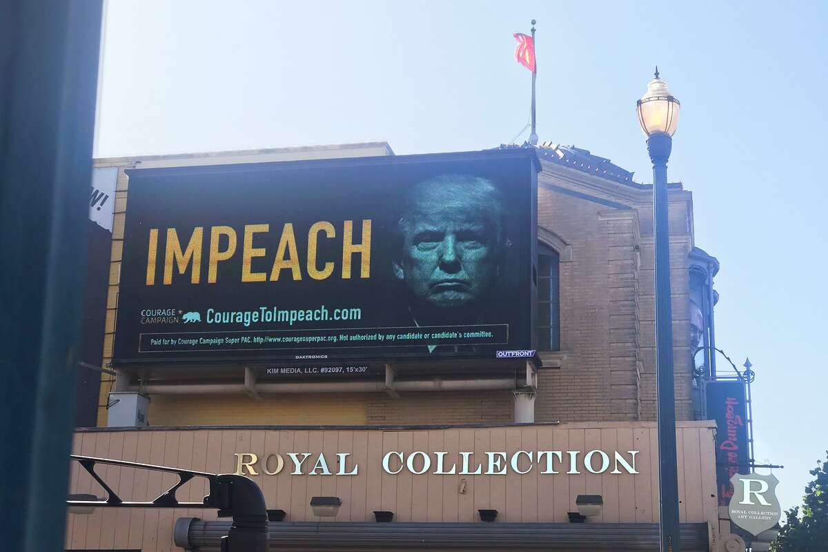 Among the sea lions, crab cocktails and swarms of tourists in San Francisco's Fisherman's Wharf neighborhood, a massive billboard featuring a steely-looking President Donald Trump popped up on Tuesday.
