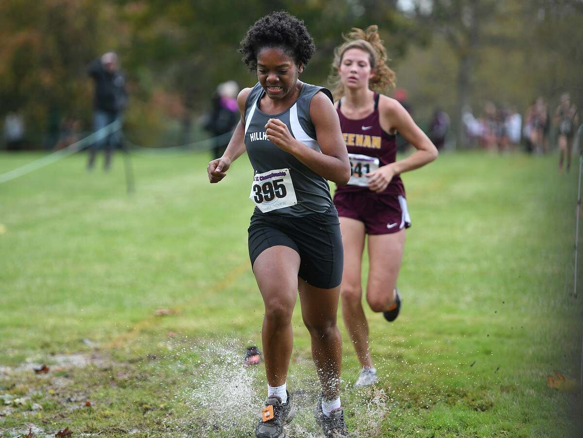 Hillhouse's Sharmaine Donaldson splashes through flooded grass on the way to the finish at the SCC Cross Country Championships at East Shore Park in New Haven, Conn. on Thursday, October 17, 2019.