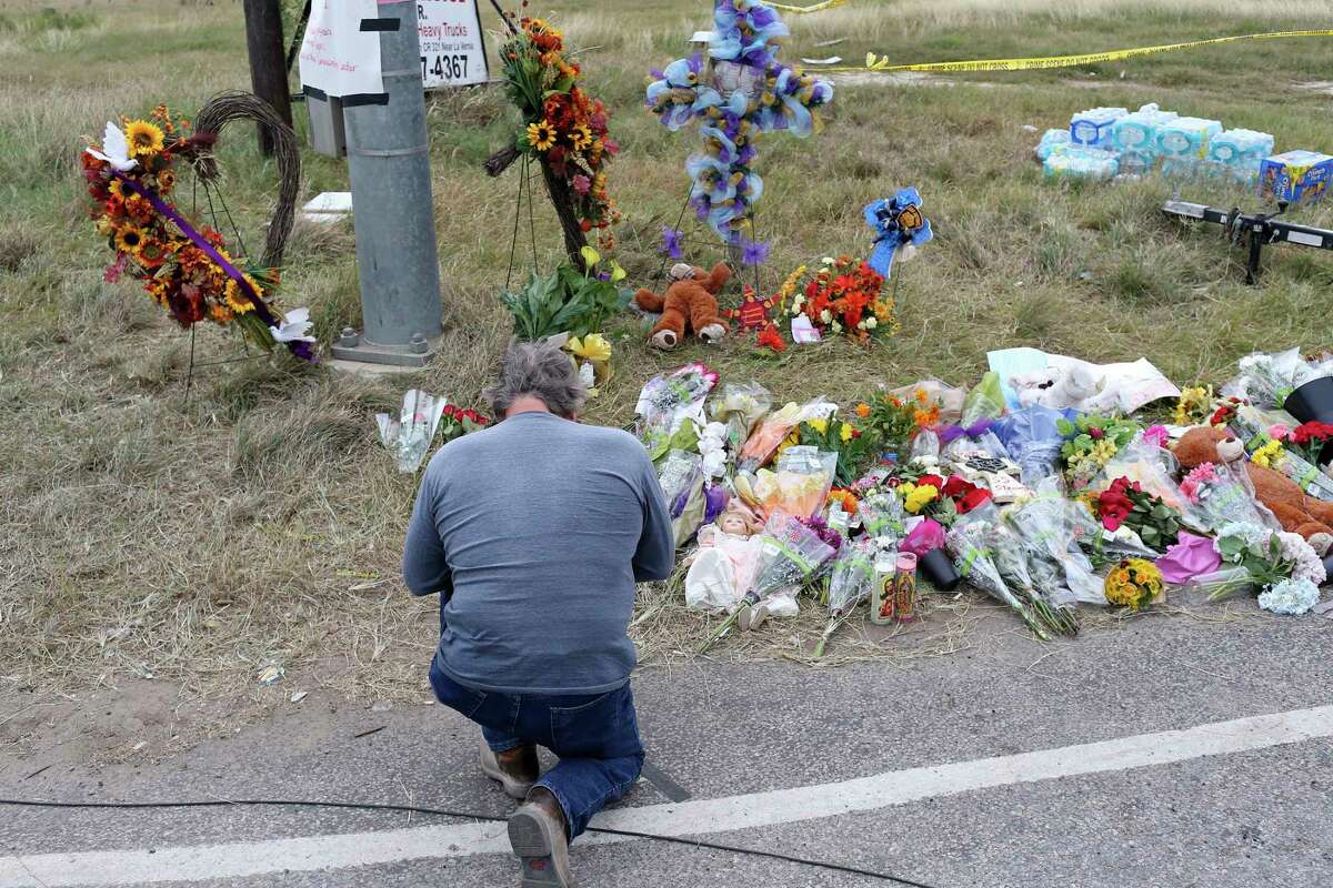 A man prays by a memorial for the Sutherland Springs, Texas First Baptist Church victims, Wednesday, Nov. 8, 2017. On Sunday, Devin Patrick Kelley, 26, walked in on worshippers and killed 26 women, children and men, injuring dozens others.