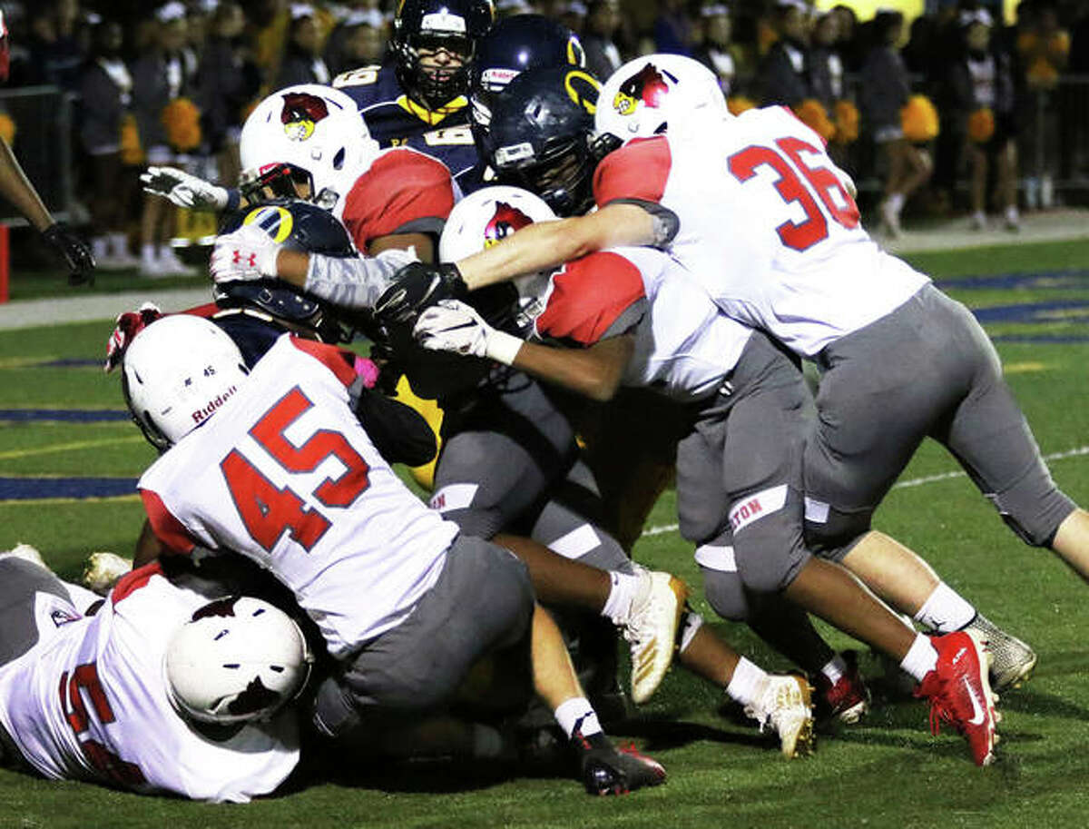 Alton kickoff unit stacks up O’Fallon’s return inside the 5-yard line during a Redbirds’ SWC victory Oct. 4 in O’Fallon. The Redbirds close SWC play Friday at Belleville West before returning home for a Week 9 game vs. DeKalb.