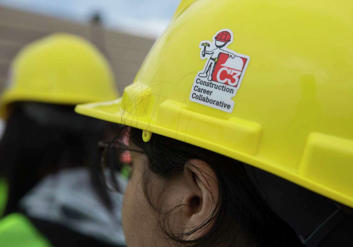 Nimitz High School 10th-grader Joselyn Toledo wears a construction hard hat at the She Builds Houston, a conference for middle and high school students aimed at encouraging girls to join the construction industry, at M.O. Campbell Educational Center on Thursday, Oct. 17, 2019, in Houston. More than 1,000 girls from the Aldine ISD participated the conference.
