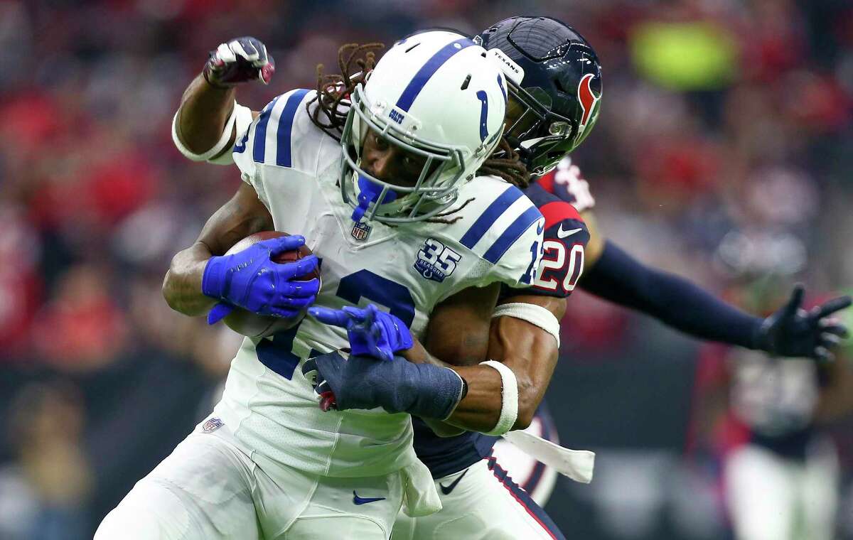 Indianapolis Colts wide receiver T.Y. Hilton (13) is tackled by Houston Texans strong safety Justin Reid (20) on a 60-yard gain during the second quarter of an NFL game at NRG Stadium Sunday, Dec. 9, 2018, in Houston. The Colts won 24-21.