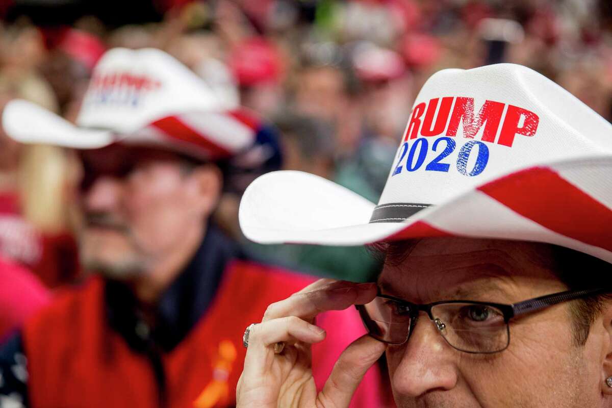 Members of the audience wear "Trump 2020" cowboy hats as President Donald Trump speaks at a campaign rally at American Airlines Arena in Dallas, Texas, Thursday, Oct. 17, 2019. (AP Photo/Andrew Harnik)