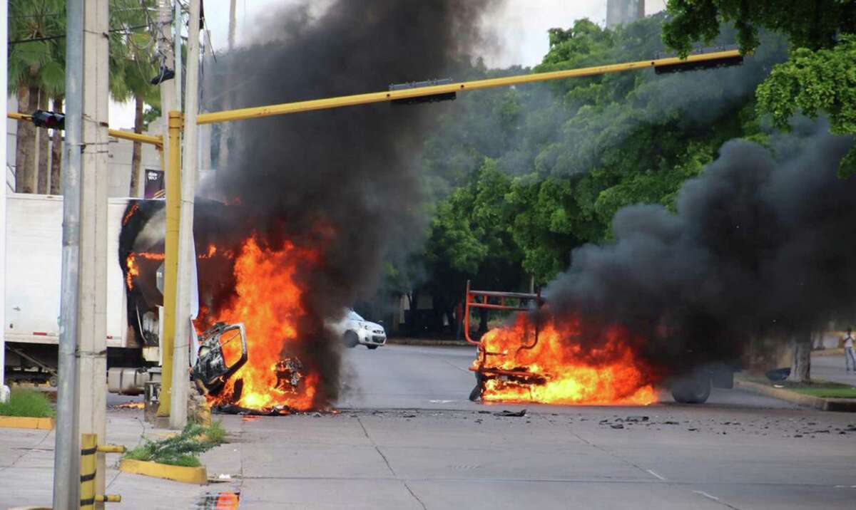 The vehicles burn on a street in Culiacán, Sinaloa state, Mexico, on October 17, 2019.