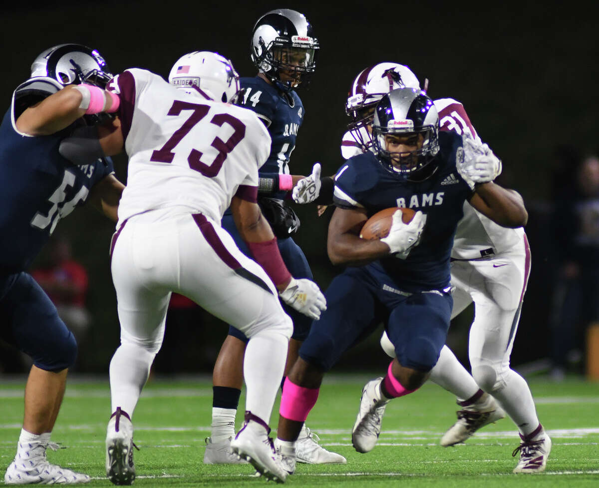 Cy Ridge senior running back Leslie Wellington, right, battles for yards against Northbrook defenders Eloy Gutierrez (73) and senior defensive lineman Jorge Turrbiartes (31) during a play early in the 2nd quarter of their District 17-6A matchup at Pridgeon Stadium in Cypress on Oct. 17, 2019.