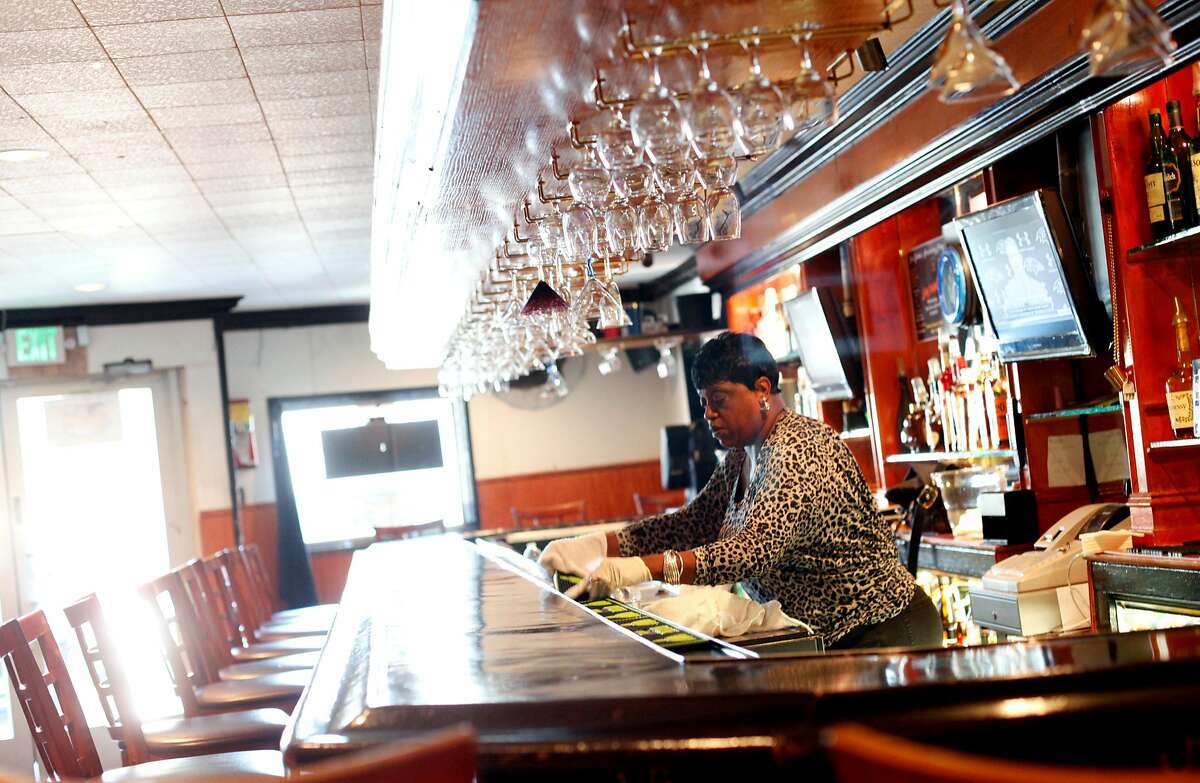 Bartender Denise Tucker gets ready to open at Sam Jordan's Bar in San Francisco, Calif., Monday, January 21, 2013. The bar recently obtained landmark status.