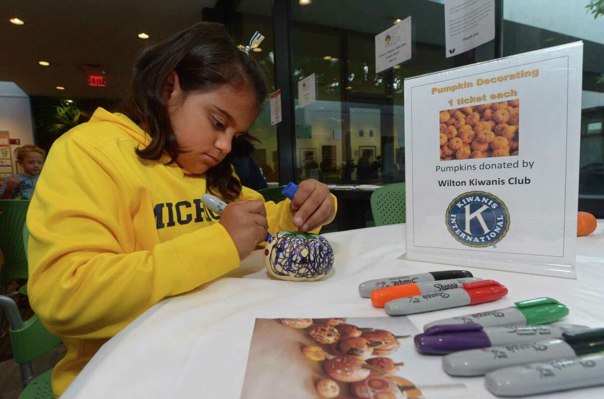 Wilton resident Cristine Perez, 8, decorates a pumpkin at the Kiwanis table during The Wilton Library’s annual Innovation Day last year. Innovation Day this year is Saturday, Oct. 19.