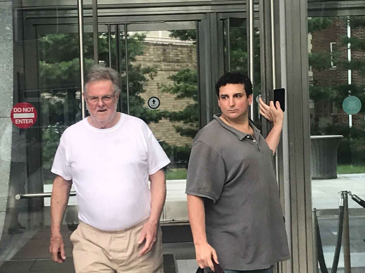 Family law attorney Ridgely Brown, 72, walking out of the Stamford courthouse with his bondsman, Jonny Barber, and a female employee after posting a $500,000 bond and being released from jail.