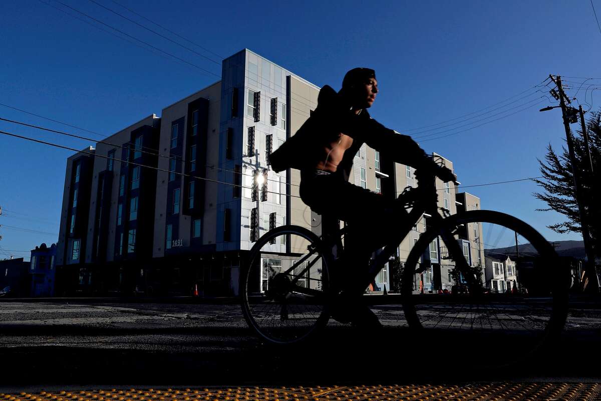 A man on a bicycle rides near Parcel Q, a new mixed income community built adjacent to Sunnydale and will have families from Sunnydale move soon in San Francsico, Calif., on Thursday, October 17, 2019. Parcel Q is part of the Hope SF, which looks to create mixed income housing without displacing original residents.