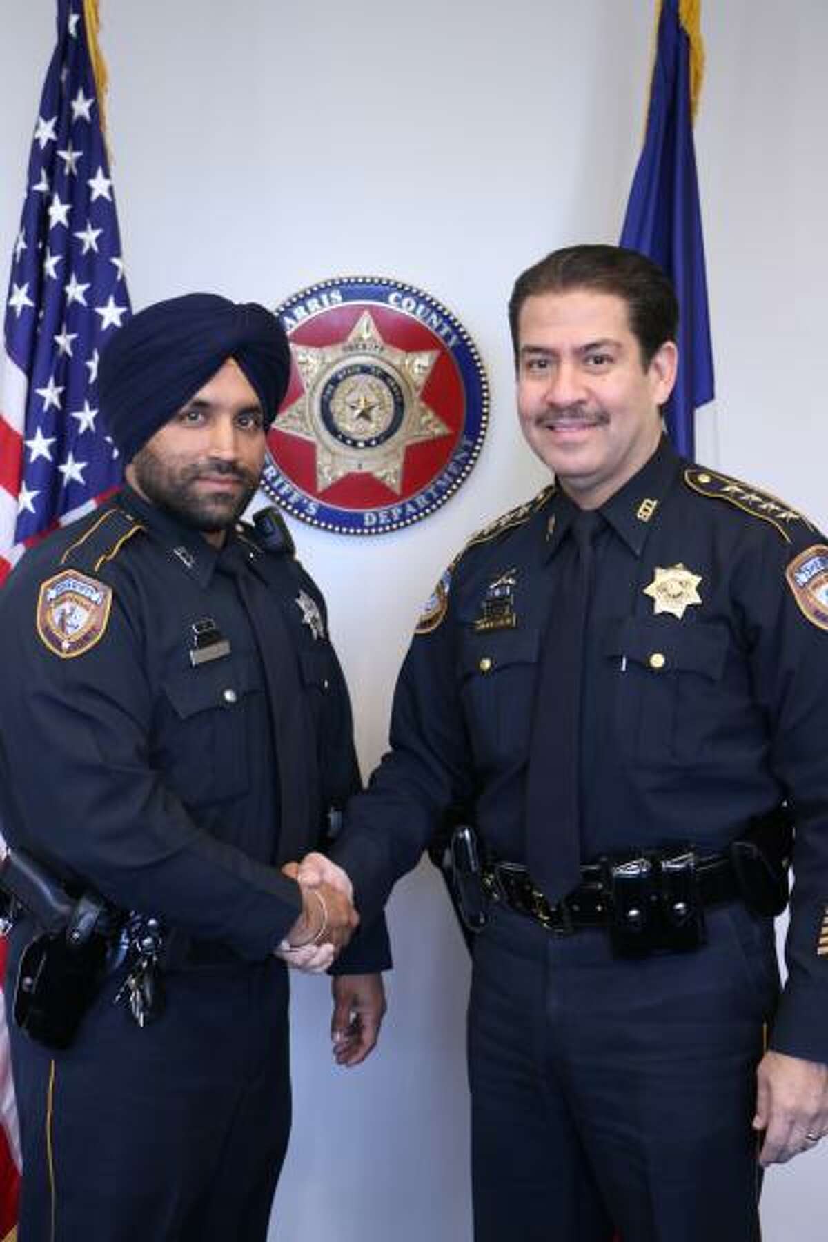 Harris County Sheriff's Deputy Sandeep Dhaliwal, left, and then-sheriff Adrian Garcia. Garcia, now the Harris County commissioner for Precinct 2, wants to name the Harris County Criminal Justice Center after Dhaliwal.