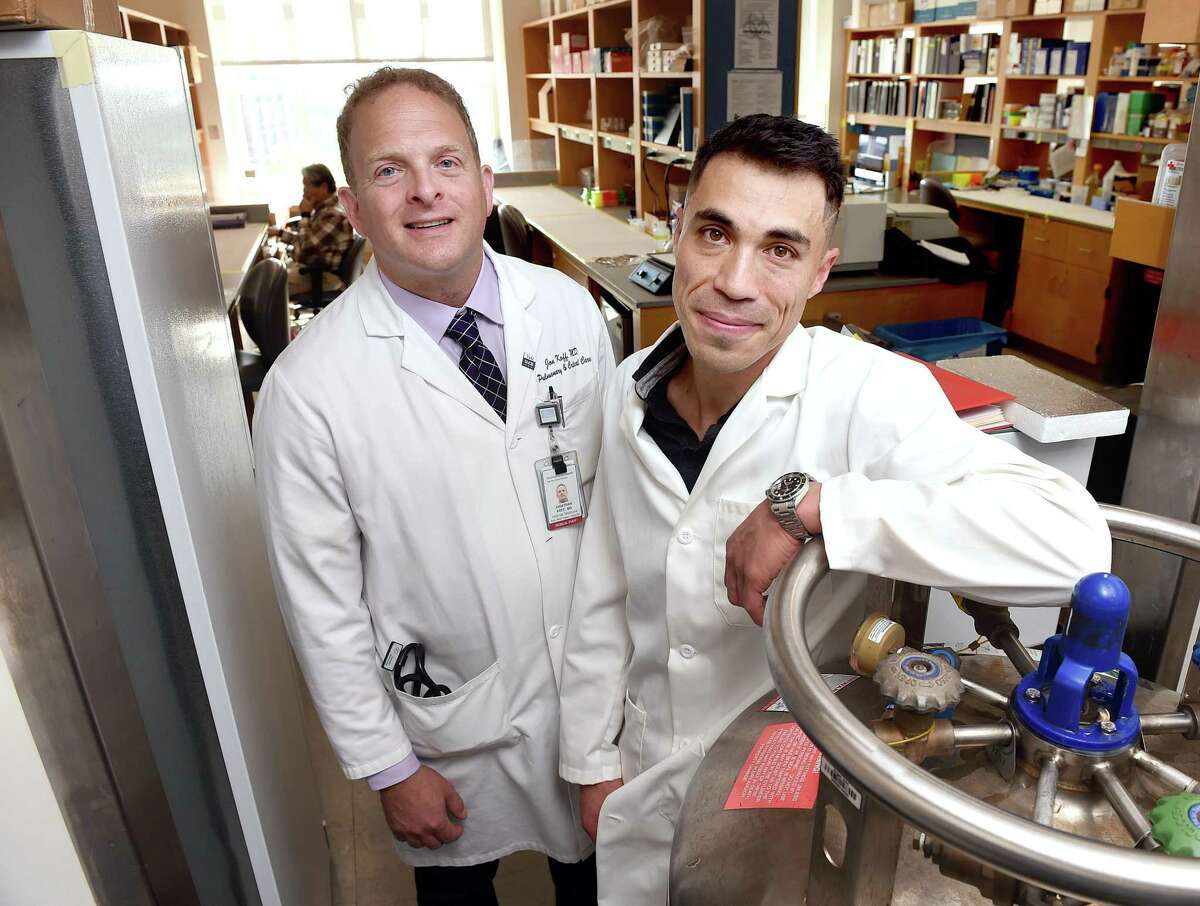 Dr. Jon Koff, left, and Ben Chan are working with phages — viruses that kill antibiotic-resistant bacteria. They are photographed in the Anlyan Center at the Yale School of Medicine in New Haven on Oct. 14, 2019.