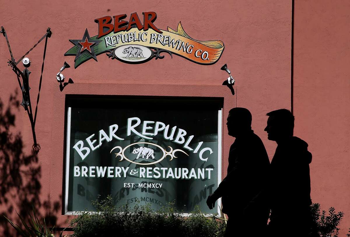 Pedestrians walk by the Bear Republic Brewery and Restaurant on February 21, 2014 in Healdsburg, California.