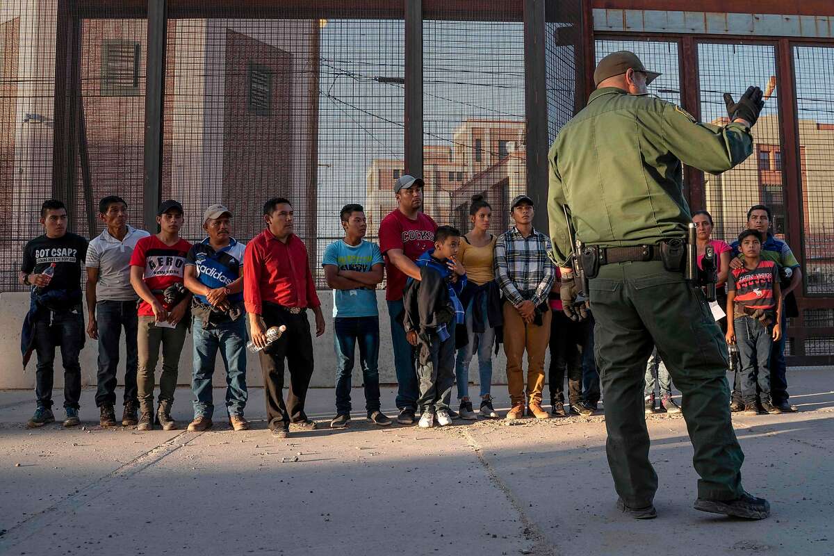 (FILES) In this file photo taken on May 16, 2019 migrants, mostly from Central America, que to board a van which will take them to a processing center, in El Paso, Texas. - A US federal judge has dealt a new blow to President Donald Trump's anti-immigration efforts, blocking a measure meant to relax the criteria for deporting undocumented migrants. The ruling, issued late on September 27, 2019, concerns a policy known as expedited removal under which migrants previously found within 100 miles (160 kilometers) of the border within 14 days of their arrival were deported without appearing before an immigration judge. (Photo by Paul Ratje / AFP)PAUL RATJE/AFP/Getty Images