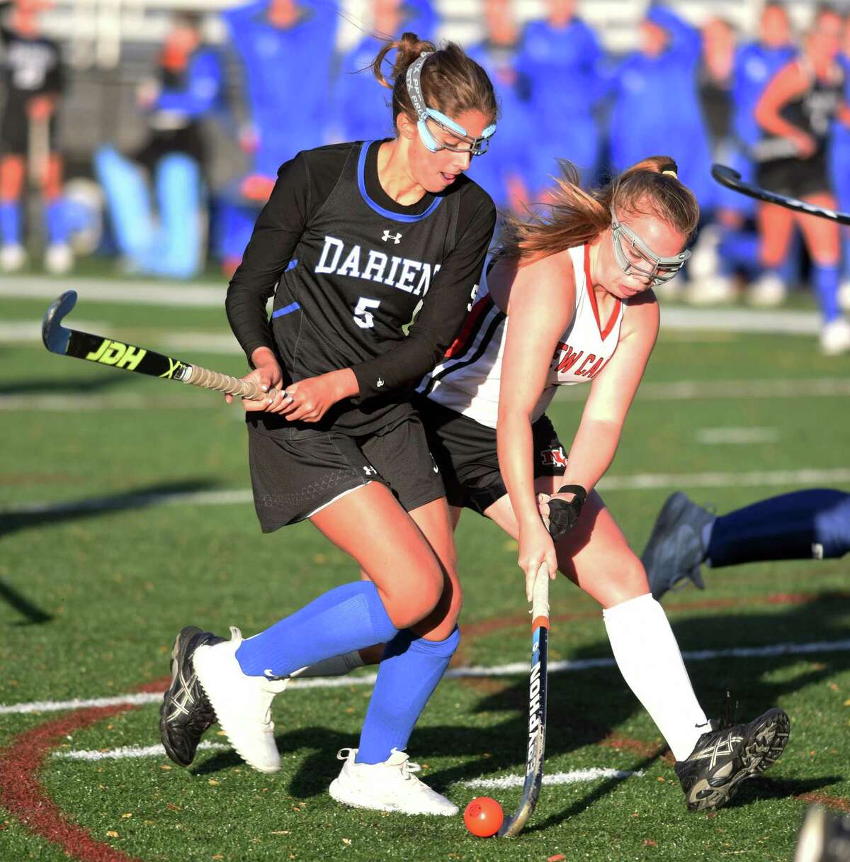 Darien’s Mackenzie O’Shea (5) and New Canaan’s Keira Cooney battle for the ball during a field hockey game at Dunning Field in New Canaan on Friday, Oct. 18, 2019.