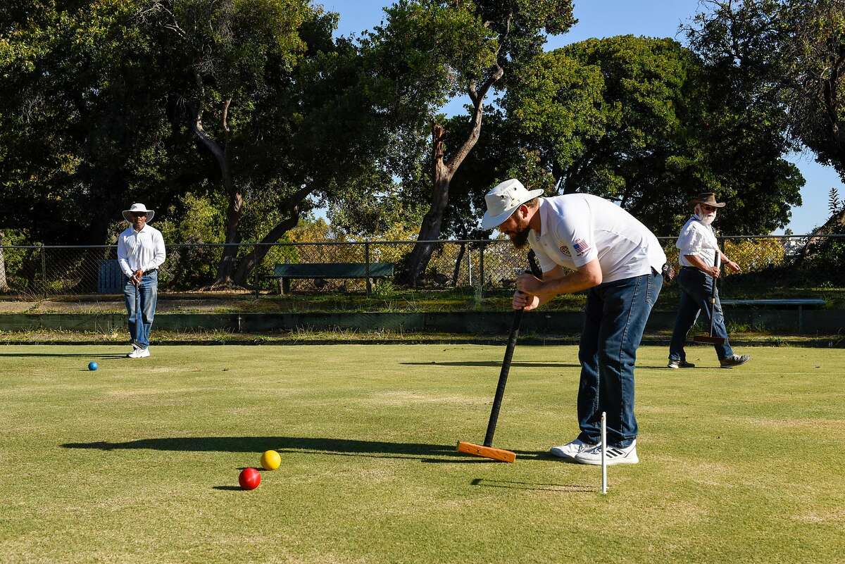 Reuben Edwards, Ben Rothman and Rick Smith world champion of golf croquet, practice at the Oakland Croquet Club on October 17, 2019 in Oakland, Calif.