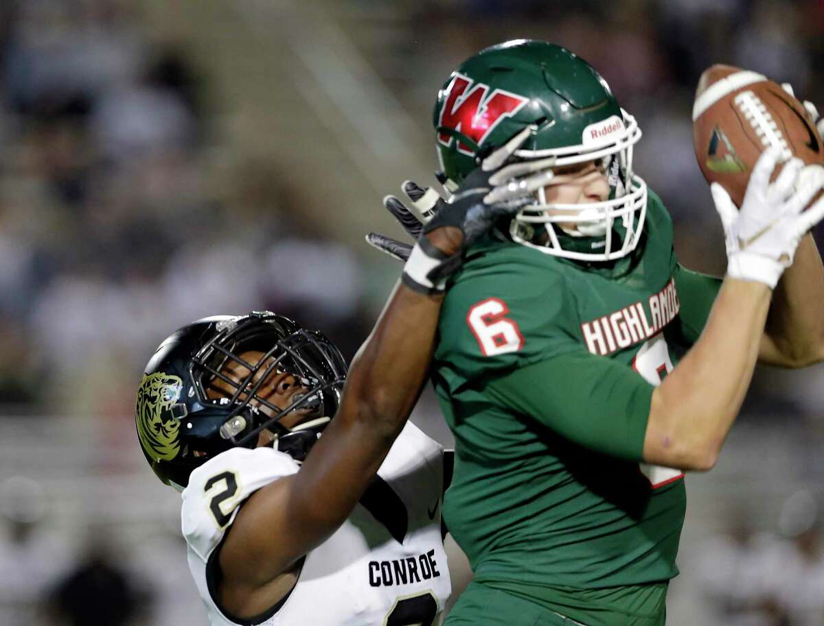 Conroe wide receiver Marcus Thomas (2) has his pass intercepted by The Woodlands defensive back Dylan Binney (6) during the first half of their game at Woodforest Bank Stadium Friday, Oct. 18, 2019 in Shenandoah, TX.
