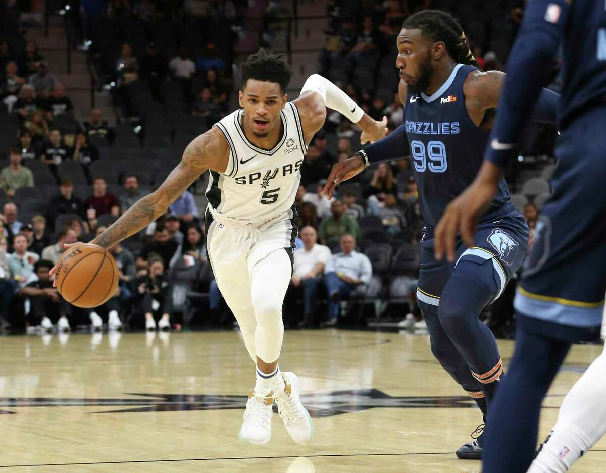 Spurs' Dejounte Murray (05) drives toward the basket against Memphis Grizzlies' Jae Crowder (99) in pre-season action at the AT&T Center on Friday, Oct. 18, 2019. (Kin Man Hui/San Antonio Express-News)