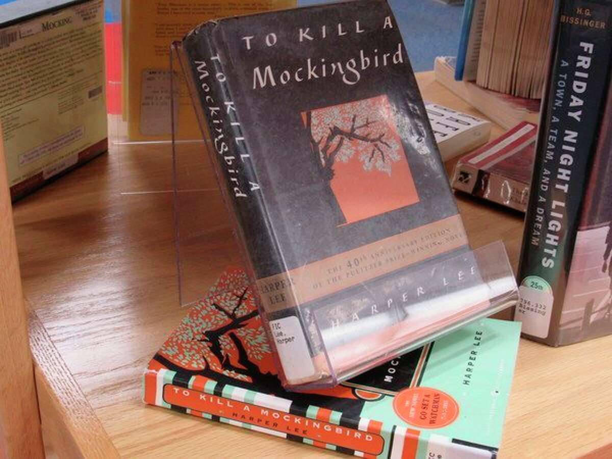 A selection of challenged books sits on display at Grace A. Dow Memorial Library during Banned Books Week, Sept. 22-28. "To Kill a Mockingbird" has been challenged in the past for violence, racism and racist language. "Friday Night Lights" has been challenged for its sexual content, offensive language and racism. (Victoria Ritter/vritter@mdn.net)