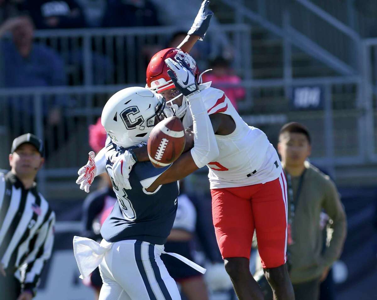 Connecticut defensive back Abiola Olaniyan (18) breaks up a pass intended for Houston wide receiver Marquez Stevenson (5) in the end zone during the first half of an NCAA college football game, Saturday, Oct. 19, 2019, in East Hartford, Conn. (AP Photo/Stephen Dunn)