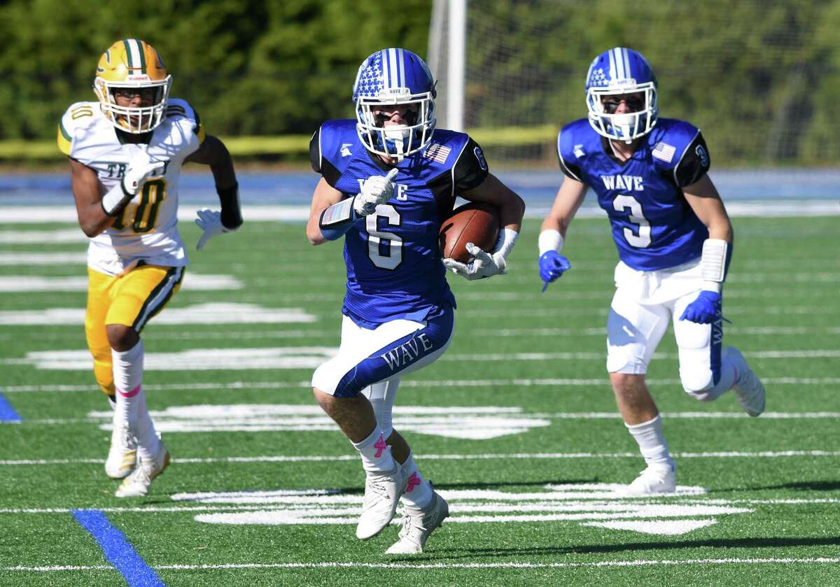 Darien’s Michael Minicus (6) breaks free for a touchdown with Trinity Catholic/Wright Tech’s Luigi Bernard (10) in pursuit during a football game at Darien High School on Saturday, Oct. 19, 2019.
