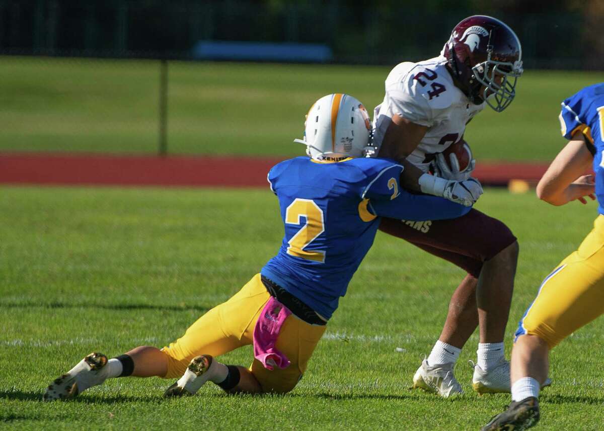 Queensbury's Nate Gillingham tackles Burnt Hills running back Diamonte Sanderson during the Class A Grasso Division title on Saturday, Oct. 19, 2019, in Queensbury, N.Y. (Jenn March, Special to the Times Union )
