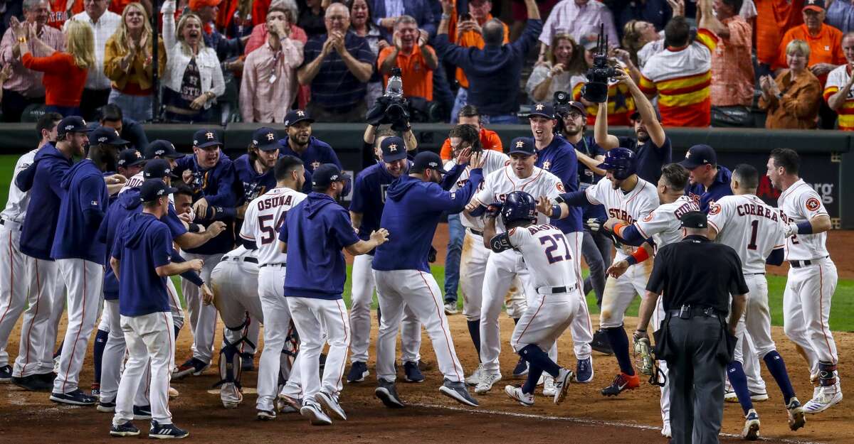 The Astros greet Jose Altuve (27) at home plate after his two-run, walkoff homer to beat the Yankees in Game 6 of the American League Championship Series on Saturday night.