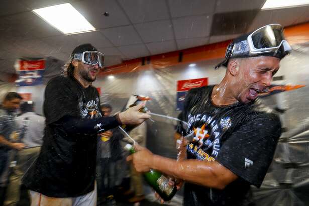 Houston Astros left fielder Michael Brantley (23) celebrates in the clubhouse after the Astros won the American League Championship Series at Minute Maid Park in Houston on Saturday, Oct. 19, 2019.