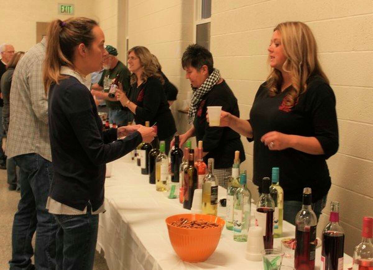 Volunteers with the Reed City General Federation of Women's Clubs handed out samples during the annual Autumn Beer and Wine Fest. This event raises money for the organization which they then donate back to the community to support a variety of projects. (Herald Review photo/Taylor Fussman)