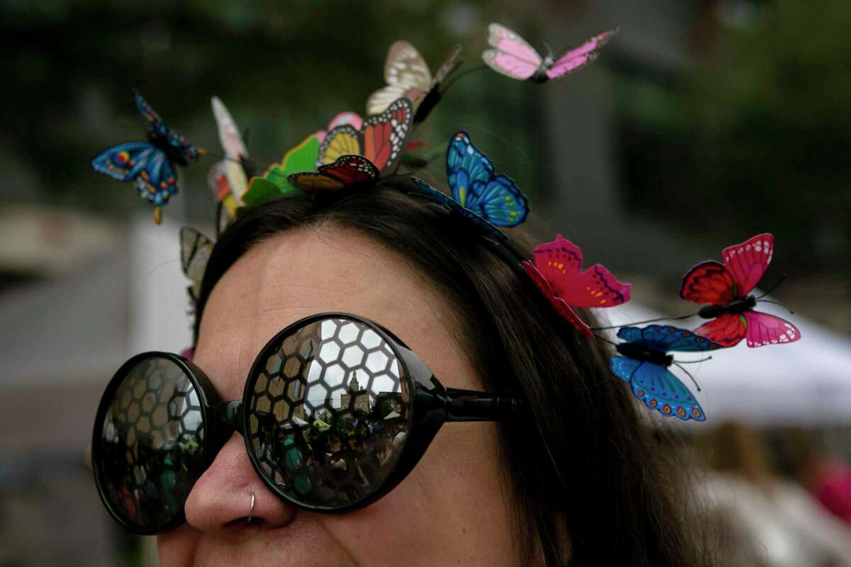Chrissy Hejny of Austin poses wearing butterfly themed accessories during 4th annual Monarch Butterfly and Pollinator Festival at the Pearl in San Antonio, Texas, Oct. 20, 2019.